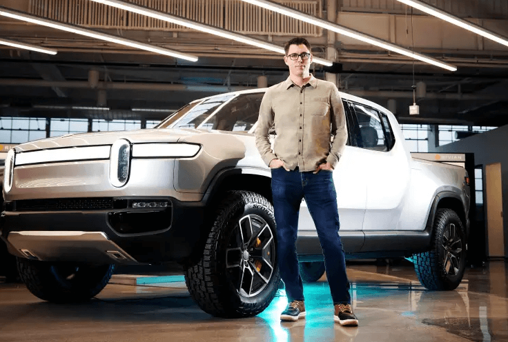 RockFlow: Rivian Founder Scaringe Standing in Front of the R1T